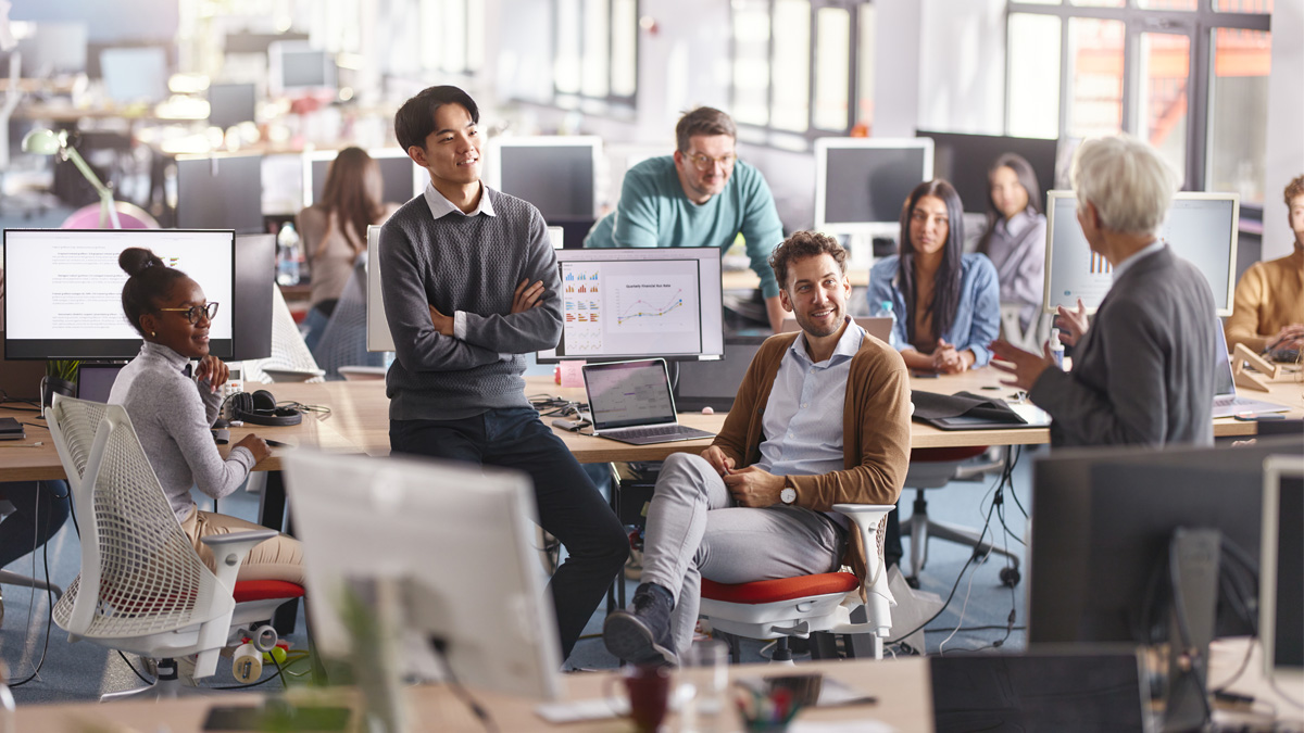 Programmers listening to their CEO during a meeting in the office